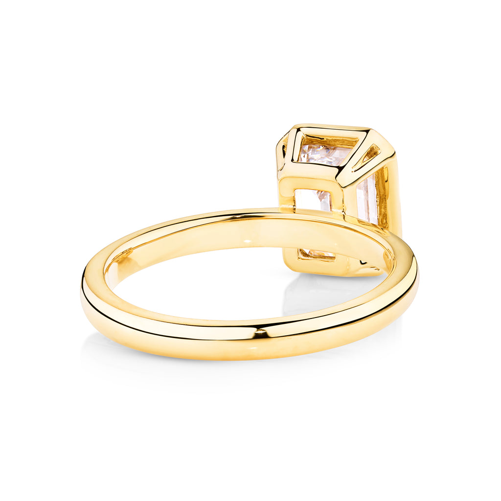 yellow gold bezel set emerald cut diamond engagement ring set in a modern bezel setting. This beautiful engagement ring can be made with lab grown or natural diamonds. Custom made engagement rings sunshine coast, Buderim