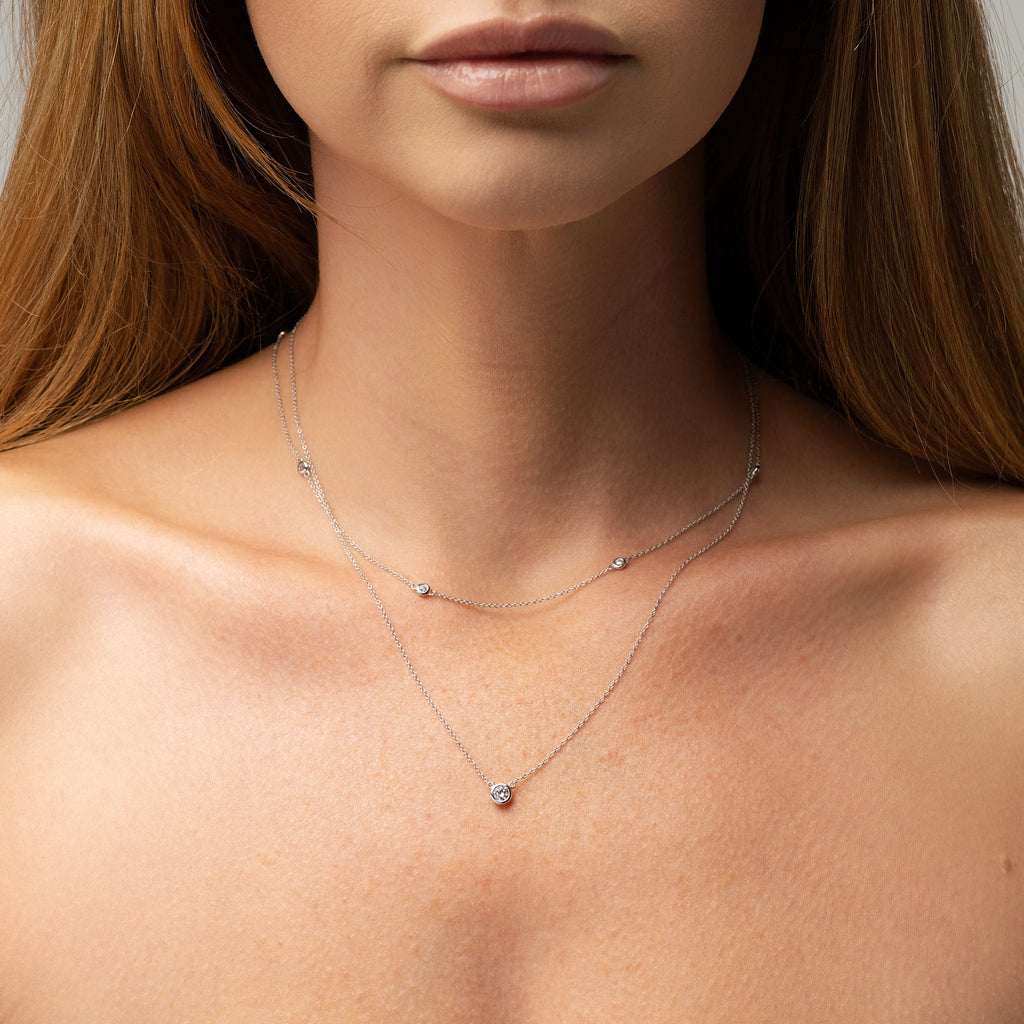 Layering necklaces example. 9ct white gold delicate diamond necklace with 3 round diamonds. Sunshine Coast Jewellers for custom made jewellery and fine jewellery.