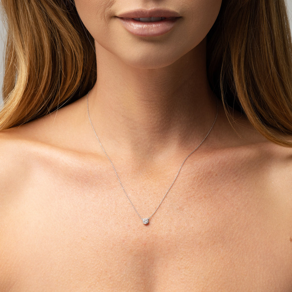 Picture of necklace on models neck. 9ct bezel set round diamond necklace with white gold chain. This beautiful necklace can be made with a lab grown or natural diamond. Custom made engagement rings and fine jewellery Sunshine Coast, Buderim. Australian made necklaces. 