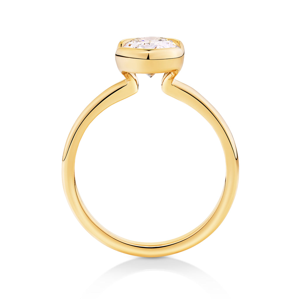 side view of 14ct yellow gold modern engagement ring sunshine coast with an oval cut diamond in a half bezel setting. unique and modern engagement ring sunshine coast