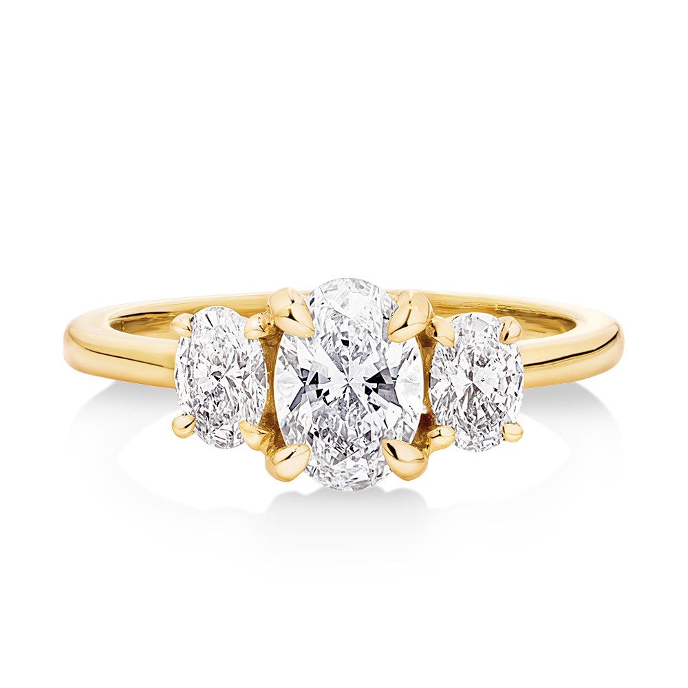 14ct yellow gold trilogy oval cut diamond engagement ring featuring 3 oval lab grown diamonds set in petite claw setting. This beautiful engagement ring can be made with lab grown or natural diamonds. Custom made engagement rings sunshine coast, Buderim. Australian made engagement rings