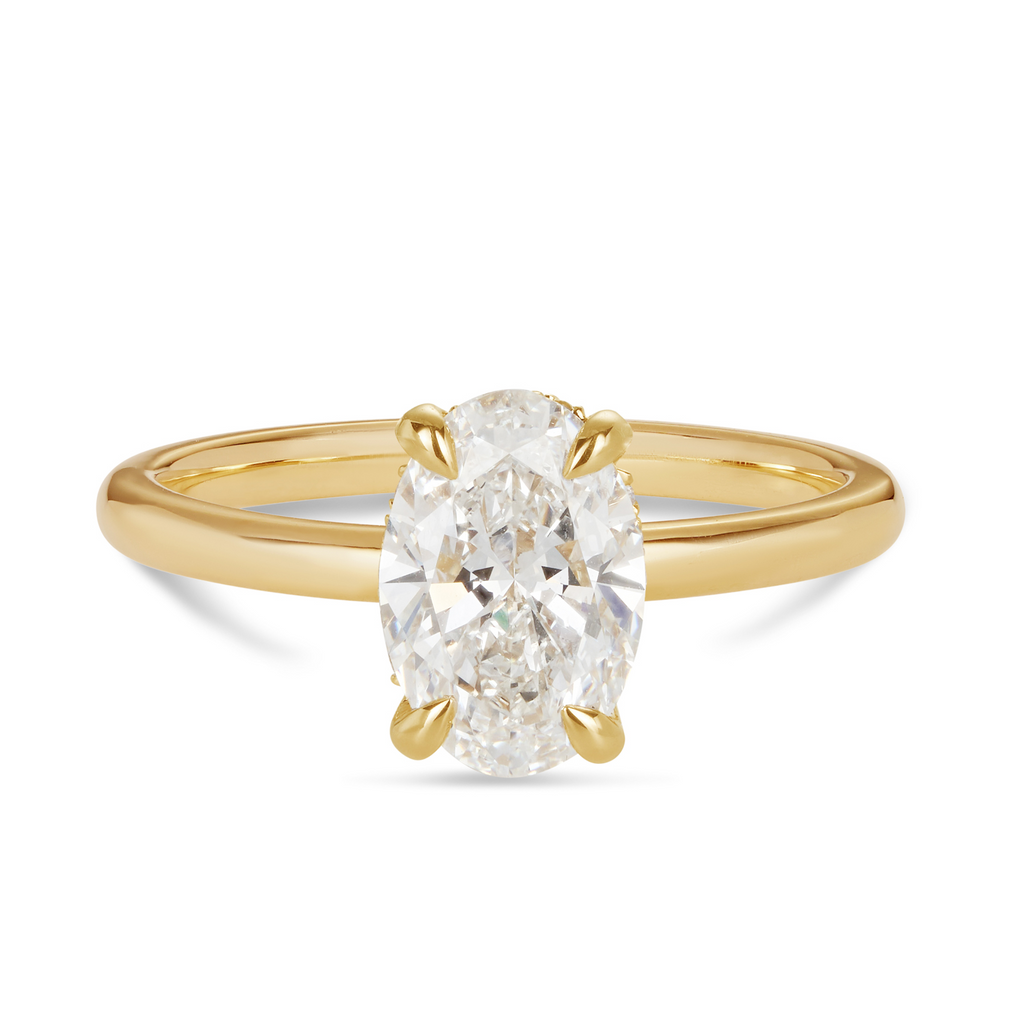 14ct yellow gold custom made engagement ring featuring an oval cut lab grown, cultured, diamond set in a petite 4 claw setting with a hidden halo. Our rings are designed at our Sunshine Coast Jeweller located in Buderim and are beautiful engagement rings and all Australian made