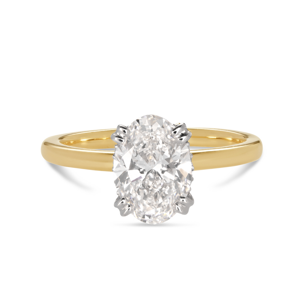 18ct yellow gold custom made engagement ring featuring an oval cut lab grown, cultured, diamond set in a petite 4 double claw platinum setting. Our rings are designed at our Sunshine Coast Jeweller located in Buderim and are All Australian made, beautiful, engagement rings.