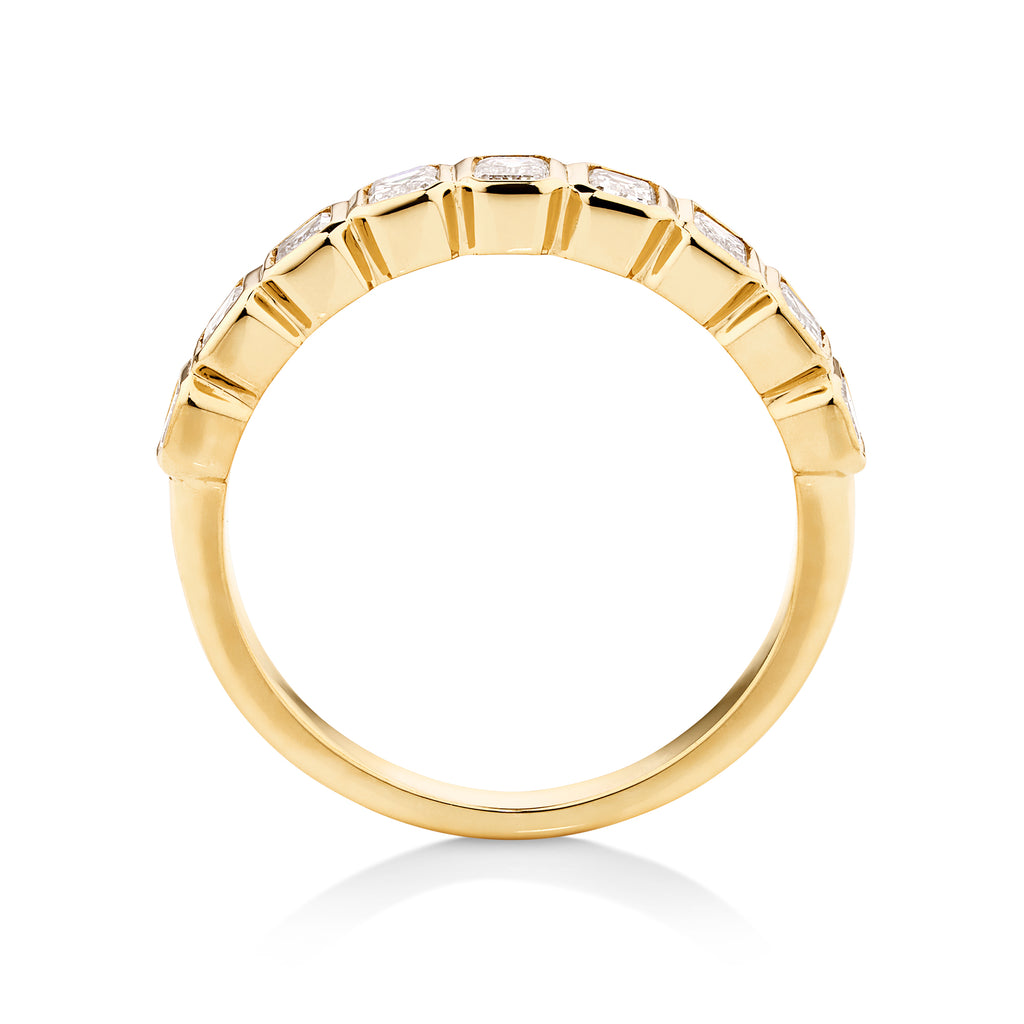 Bezel set radiant cut statement wedding band in yellow gold