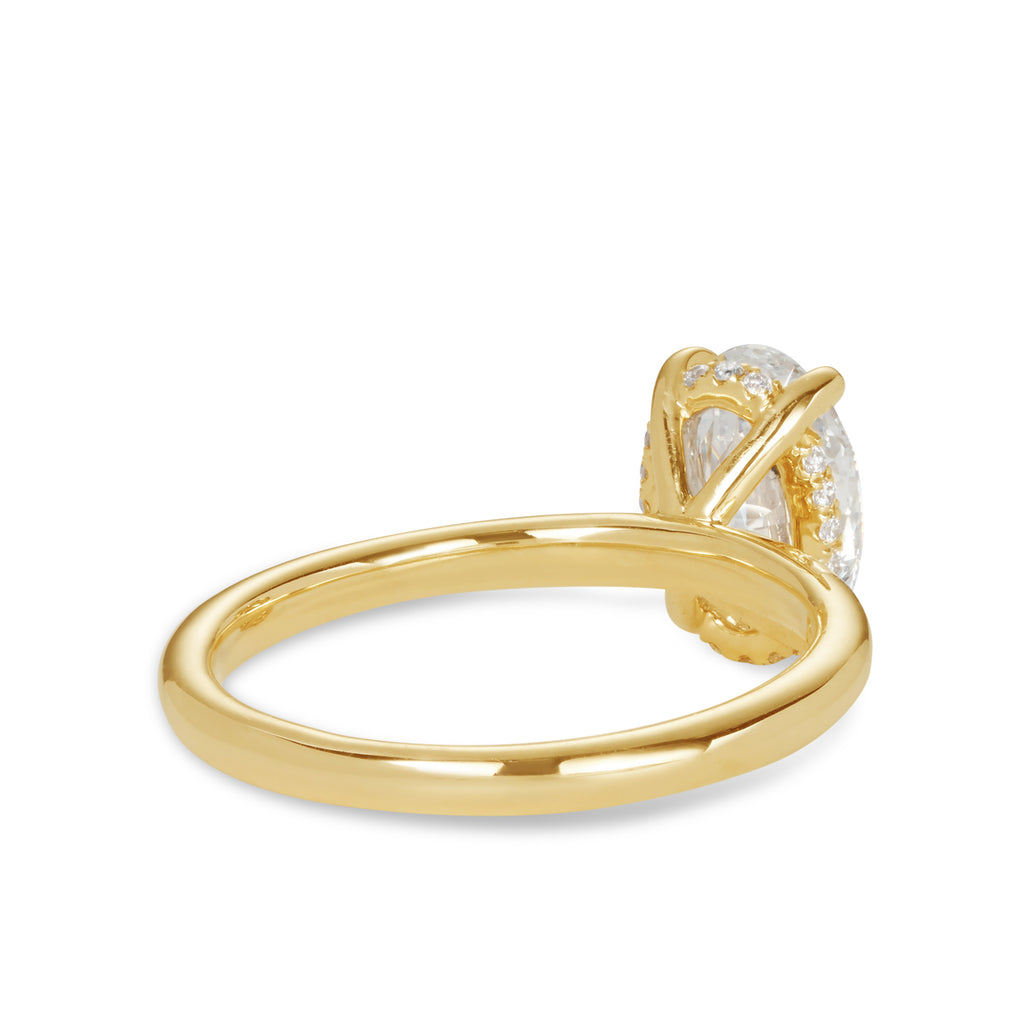 14ct yellow gold custom made engagement ring featuring an oval cut lab grown, cultured, diamond set in a petite 4 claw setting with a hidden halo. Our rings are designed at our Sunshine Coast Jeweller located in Buderim and are beautiful engagement rings and all Australian made 