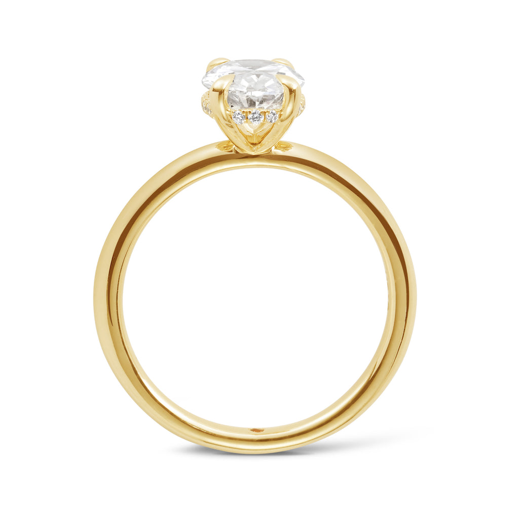 Side view of a 14ct yellow gold custom made engagement ring featuring an oval cut lab grown, cultured, diamond set in a petite 4 claw setting with a hidden halo. Our rings are designed at our Sunshine Coast Jeweller located in Buderim and are beautiful engagement rings and all Australian made 