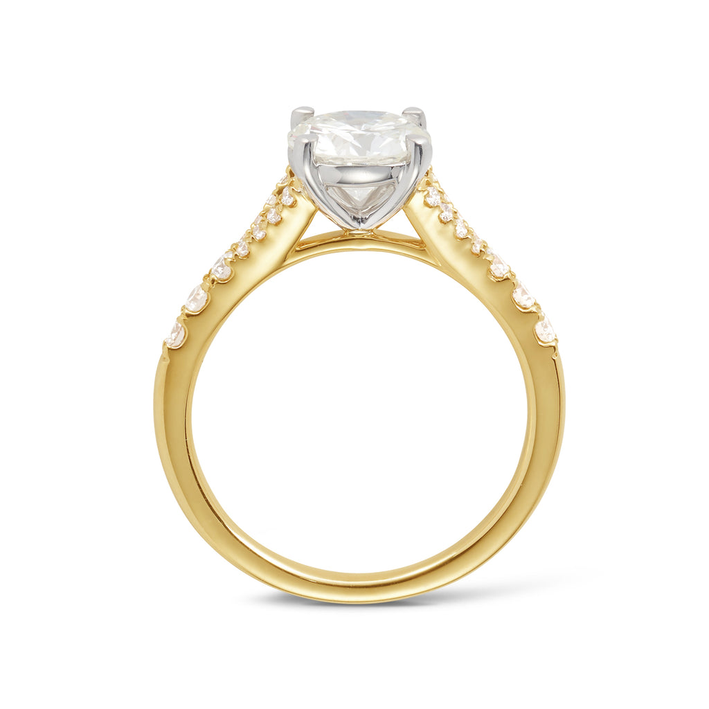 side view of an 18ct yellow gold custom made engagement ring featuring a brilliant round natural diamond set in a petite 4 claw white gold setting with a split diamond band. Our rings are designed at our Sunshine Coast Jeweller located in Buderim and are All Australian made, beautiful, engagement rings.